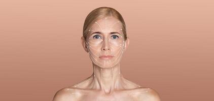 A woman stands against a soft, neutral background while focusing on her skin care routine. Her expression is serene as she engages in a pampering ritual dedicated to enhancing her beauty. photo