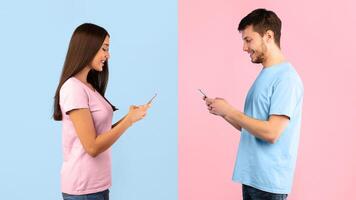 People, Technology And Communication Concept. Side view portrait of woman and man texting on mobile phone, isolated over blue and yellow studio background. Smiling couple chatting in social media photo