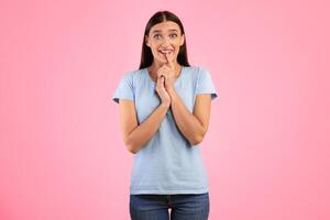 Anticipation And Expectation Concept. Portrait Of Emotional Smiling Young Lady Waiting For Something, Amazed Impressed Woman Looking At Camera, Standing And Posing Over Yellow Studio Background photo