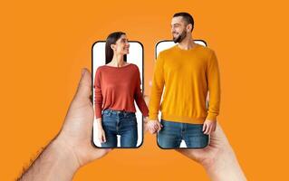 A couple shares moments of love and connection while holding hands. They are engaging with each other using their smartphones, showcasing modern communication in a cheerful environment. photo