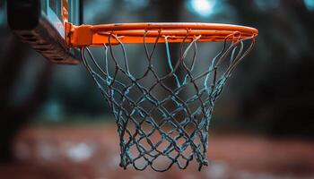 Basketball hoop hangs in an outdoor court with a blurred background on a cloudy day photo