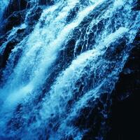 A waterfall with blue water photo