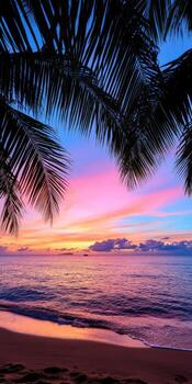 A beautiful sunset over the ocean with a palm tree in the foreground photo
