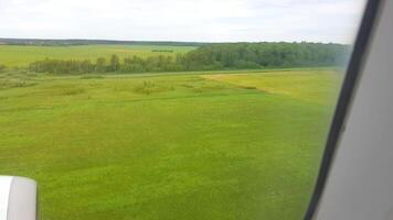 A view of the grassy field from an airplane window photo