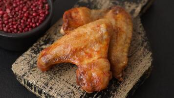 Grilled chicken wing with spices on dark concrete background video