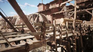 Detailed view of wooden waterwheel structure at an old mining site in daylight video