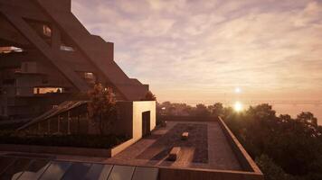 A stunning sunset over a building with a shimmering pool video