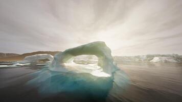A large iceberg floating on top of a body of water video