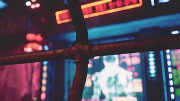 A close up of a metal fence with neon lights in the background video