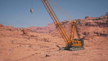 A large crane is in the middle of a desert video