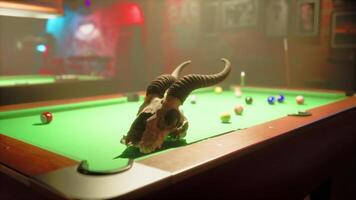 A bull skull sitting on top of a pool table video