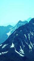 Awesome top view through clouds to high snowy mountains video