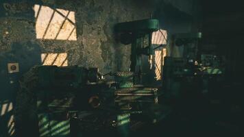 Rusty machines illuminated by golden sunlight in an abandoned workshop video
