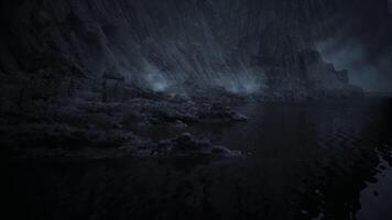 Mysterious shoreline at dusk with rocky landscape and foggy atmosphere video