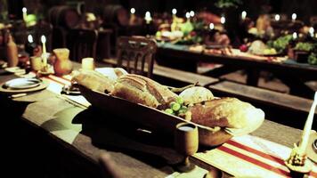 A festive banquet table adorned with various foods and drinks in a cozy setting video