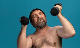 Elderly man looks determined while exercising with dumbbells in a bright setting photo