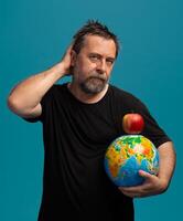 Balancing the World and Knowledge with a Simple Apple in a Creative Concept photo