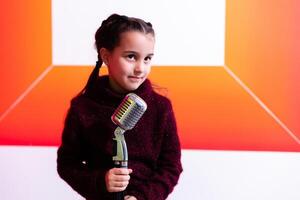 pretty little girl with the microphone in her hand photo
