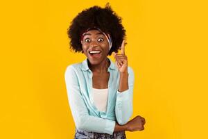 I Have Great Idea. Excited African Woman Pointing Finger Up Having Enlightment Eureka Moment Smiling To Camera Posing Standing Over Pink Studio Background. Creativity And Inspiration Concept photo