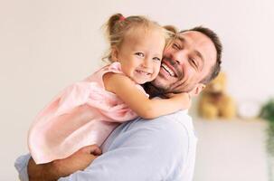 Happy Loving Family. Dad hugging his little daughter and looking at camera. Copy space, banner photo