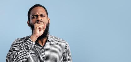 I Need Rest. Tired black man yawning covering open mouth with fist, being sleepy, can't wake up having insomnia photo