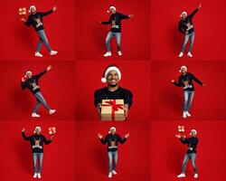 A cheerful black man wearing a festive sweater and Santa hat joyfully poses with a present against a bright red background. His playful expressions capture the excitement of the holidays. photo