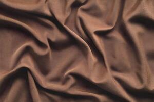 Fabric in a mocha mousse color of the year showcasing the elegance and texture of luxurious textiles used in home decor and fashion photo
