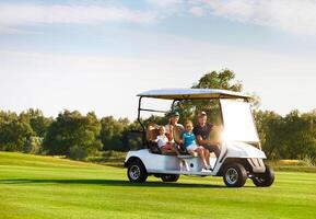 Beautiful family portrait in a cart, at the golf course photo