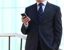 Close up of the hands of the businessman with a mobile phone photo