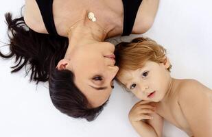 A close-up portrait in profile of a laughing mother and a cute child photo