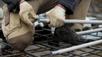 Worker Assembling Pipe Framework on Construction Site video