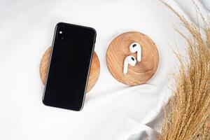 Smartphone top view with earphone isolated on white background. High resolution photo. photo