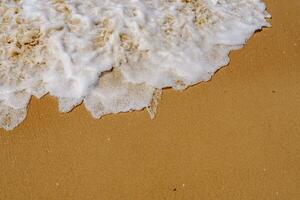 A person on a surfboard riding a wave on a beach photo