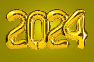 New Year 2024 celebration. Golden Yellow foil color balloons. 2024 balloons. On Yellow background photo