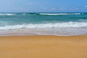 A beach with a surfboard on the sand photo