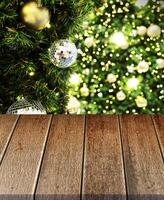Empty old wooden table in front of Christmas or happy new year time background. christmas tree with colorful balls holiday background. Product display montage photo