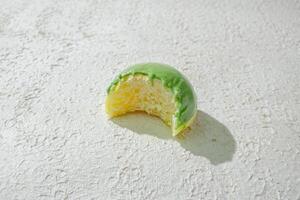 a half eaten cake on a white texture background photo