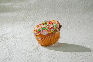 a cupcake with sprinkles on it photo