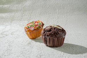 two cupcakes sitting on a table photo