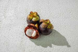 three Ripe mangosteen fruit isolated on a white background photo