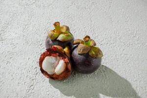 a close up of a purple mangosteen fruit with a seed inside photo