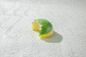 a half eaten mini donuts on a white surface photo