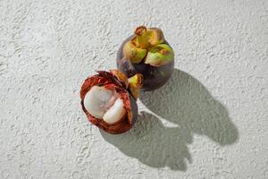 peeled mangosteen fruit isolated on white background photo