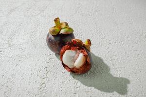 Ripe mangosteen fruit isolated on a white background photo