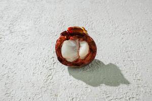 Opened one Ripe mangosteen fruit isolated on a white background photo