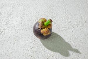 a mangosteen isolated on white texture background photo