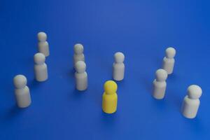 yellow wooden doll that is different from others photo