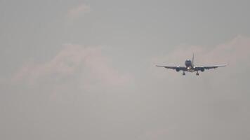 Footage of airliner approaching landing, front view. Jet plane with unrecognizable livery descending, arriving. Aircraft in the blue sky video