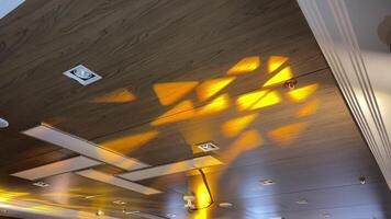 Vibrant abstract light patterns dance across a rustic wooden ceiling, creating a warm ambiance ideal for interior design and lighting inspiration to enhance spaces beautifully video