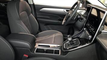Explore this stylish car interior showcasing contemporary design, comfortable seating, and high-tech controls for a driving experience filled with luxury and convenience. video